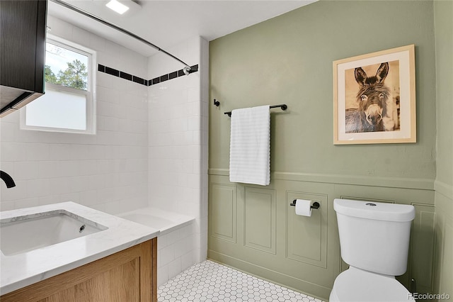 10887 Goodheart Ave, Conifer, CO 80433 - bathroom with toilet, vanity, shower / bathtub combination, tile patterned floors, and wainscoting