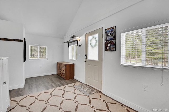 10887 Goodheart Ave, Conifer, CO 80433 - foyer entrance featuring wood finished floors, lofted ceiling, and baseboards