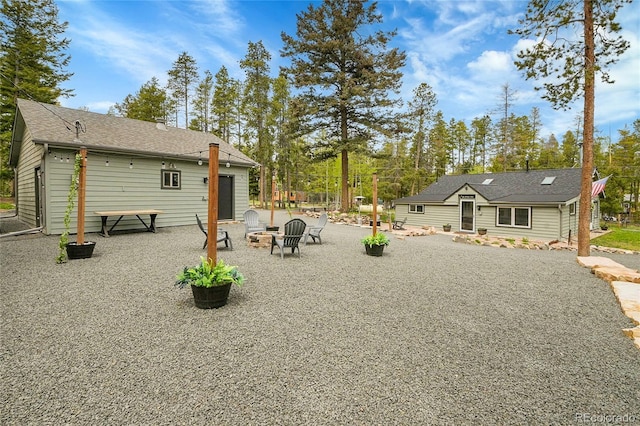 10887 Goodheart Ave, Conifer, CO 80433 - back of property with an outdoor fire pit and a patio
