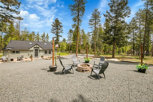 10887 Goodheart Ave, Conifer, CO 80433 - view of yard featuring a fire pit, a patio area, and view of scattered trees