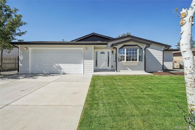 ranch-style home featuring a garage and a front yard