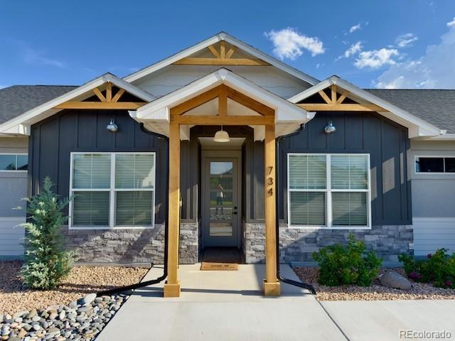 734 Flamecrest Dr, Fruita, CO 81521 - entrance to property featuring board and batten siding and stone siding