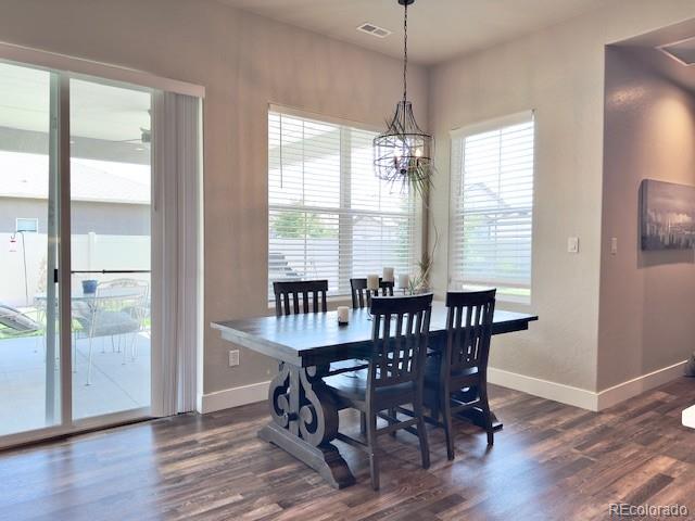 734 Flamecrest Dr, Fruita, CO 81521 - dining space with dark wood-style flooring, a chandelier, and ceiling fan