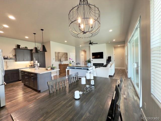 734 Flamecrest Dr, Fruita, CO 81521 - dining space featuring dark wood-style flooring, a chandelier, plenty of natural light, recessed lighting, and ceiling fan