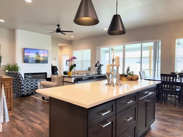 734 Flamecrest Dr, Fruita, CO 81521 - kitchen with open floor plan, a center island, dark wood-type flooring, light countertops, and recessed lighting
