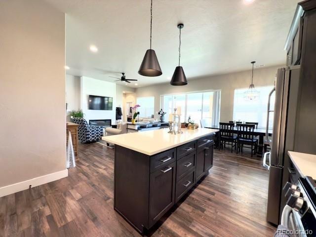 734 Flamecrest Dr, Fruita, CO 81521 - kitchen featuring light countertops, a ceiling fan, open floor plan, dark wood-type flooring, and recessed lighting