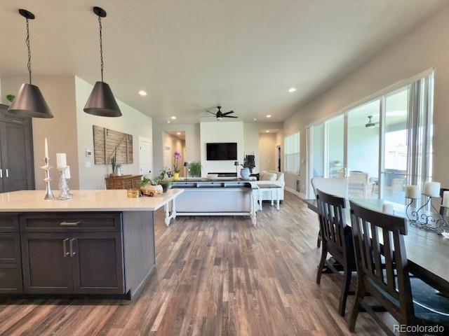 734 Flamecrest Dr, Fruita, CO 81521 - kitchen with dark wood finished floors, a ceiling fan, light countertops, open floor plan, and pendant lighting