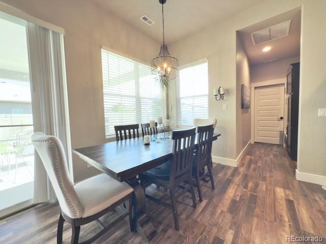 734 Flamecrest Dr, Fruita, CO 81521 - dining room featuring dark wood-style floors and a chandelier