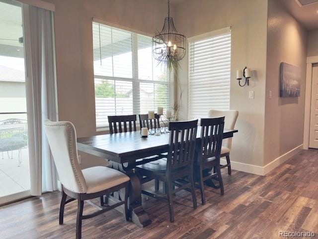 734 Flamecrest Dr, Fruita, CO 81521 - dining space featuring dark wood-style flooring and a chandelier