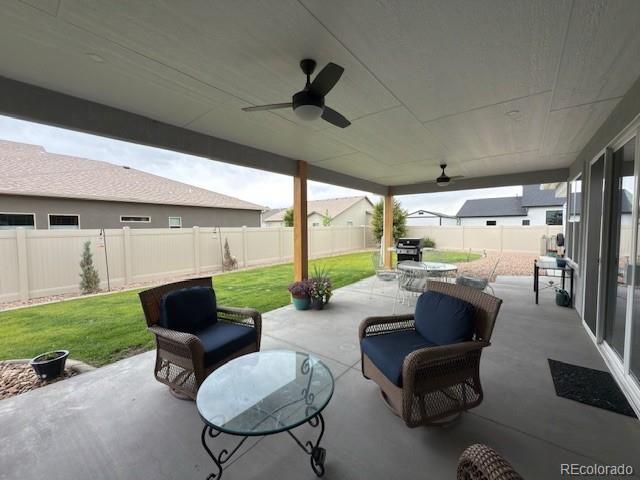 734 Flamecrest Dr, Fruita, CO 81521 - fenced backyard featuring a patio, a grill, and a ceiling fan