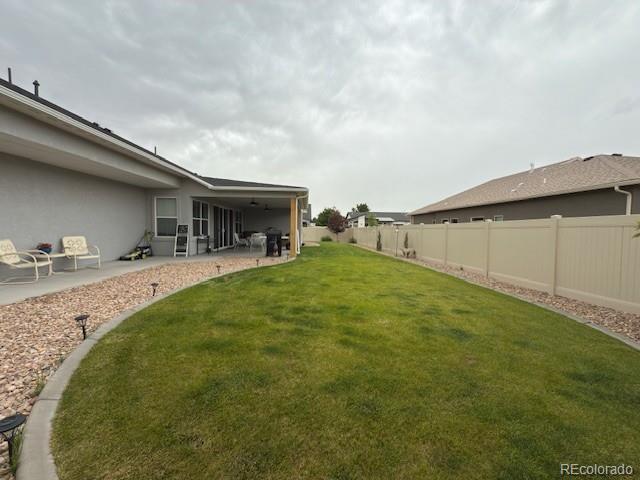 734 Flamecrest Dr, Fruita, CO 81521 - fenced backyard featuring a patio