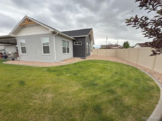 734 Flamecrest Dr, Fruita, CO 81521 - rear view of property with a fenced backyard and stucco siding