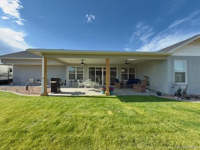 734 Flamecrest Dr, Fruita, CO 81521 - back of house featuring ceiling fan, stucco siding, a yard, and a patio area