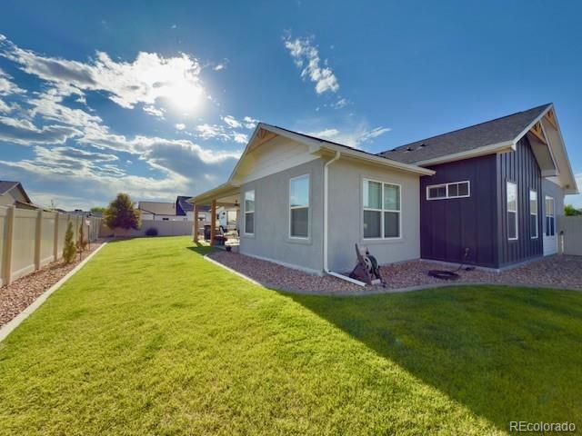 734 Flamecrest Dr, Fruita, CO 81521 - rear view of property featuring a fenced backyard and board and batten siding