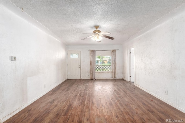 1151 Revere St, Aurora, CO 80011 - empty room with a textured ceiling, ceiling fan, wood-type flooring, baseboards, and a textured wall