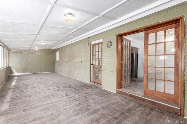1151 Revere St, Aurora, CO 80011 - unfurnished room featuring wood finished floors and brick wall