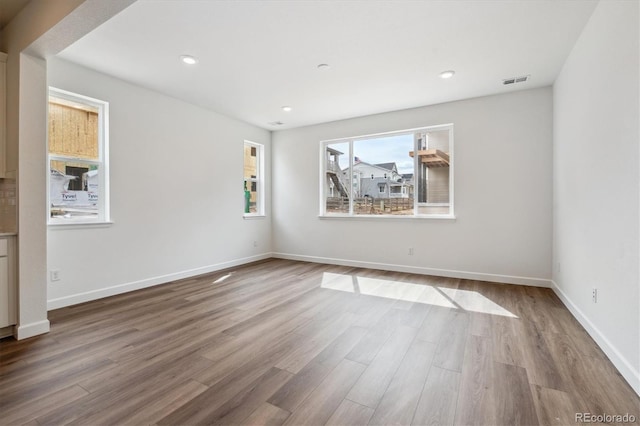 8462 Eagle River St, Littleton, CO 80125 - unfurnished room with baseboards, visible vents, recessed lighting, and wood finished floors