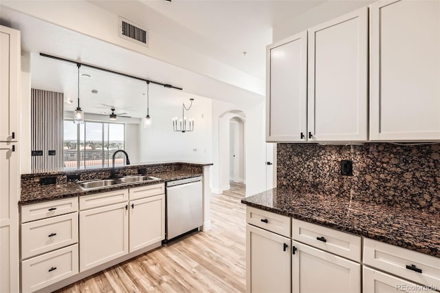 9079 E Panorama Cir Unit 419, Englewood, CO 80112 - kitchen featuring dishwasher, arched walkways, decorative backsplash, light wood-style floors, and a sink