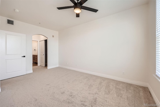9079 E Panorama Cir Unit 419, Englewood, CO 80112 - unfurnished bedroom featuring light carpet, arched walkways, baseboards, and ensuite bathroom