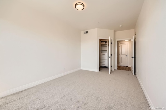 9079 E Panorama Cir Unit 419, Englewood, CO 80112 - unfurnished bedroom with light colored carpet, baseboards, and a closet
