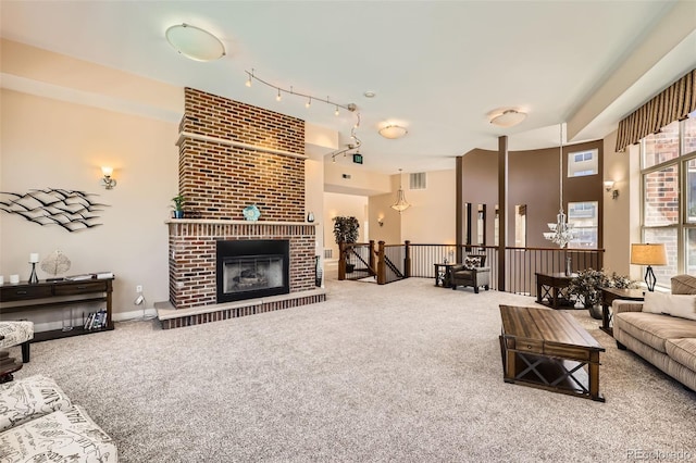 9079 E Panorama Cir Unit 419, Englewood, CO 80112 - carpeted living area featuring track lighting and a fireplace