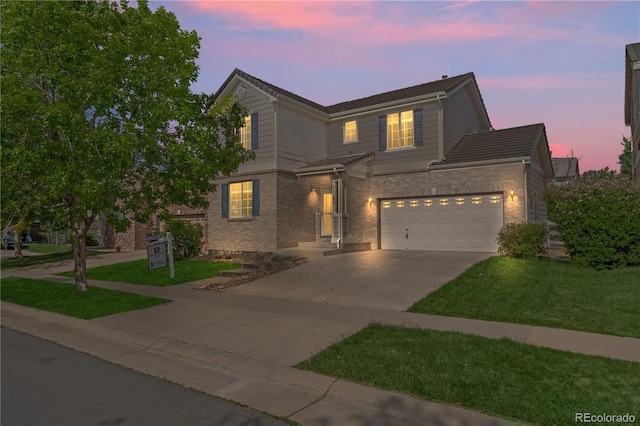 1160 S Fultondale Ct, Aurora, CO 80018 - traditional-style house featuring driveway, brick siding, a front lawn, and a garage