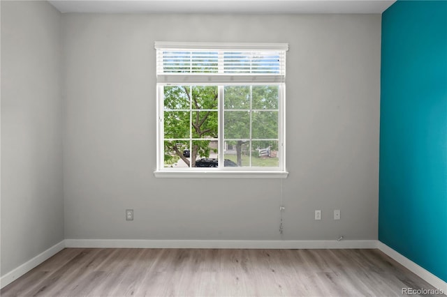 1160 S Fultondale Ct, Aurora, CO 80018 - spare room featuring plenty of natural light, light wood-style flooring, and baseboards