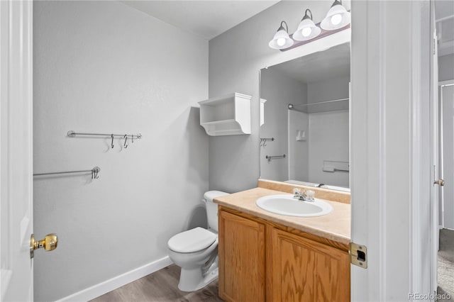 1160 S Fultondale Ct, Aurora, CO 80018 - full bathroom with toilet, vanity, wood finished floors, a shower, and baseboards