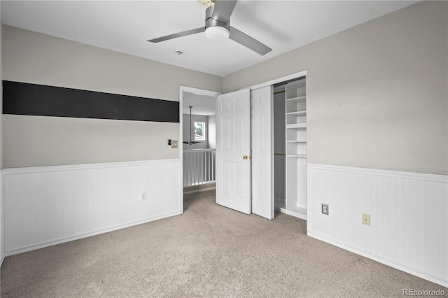 1160 S Fultondale Ct, Aurora, CO 80018 - unfurnished bedroom featuring a wainscoted wall, carpet floors, a closet, and a ceiling fan