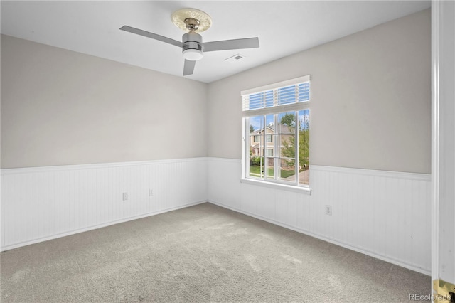 1160 S Fultondale Ct, Aurora, CO 80018 - spare room with wainscoting, ceiling fan, and carpet