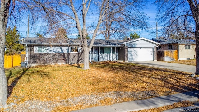 ranch-style home with a front lawn and a garage