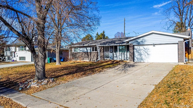 single story home with a garage and a front lawn