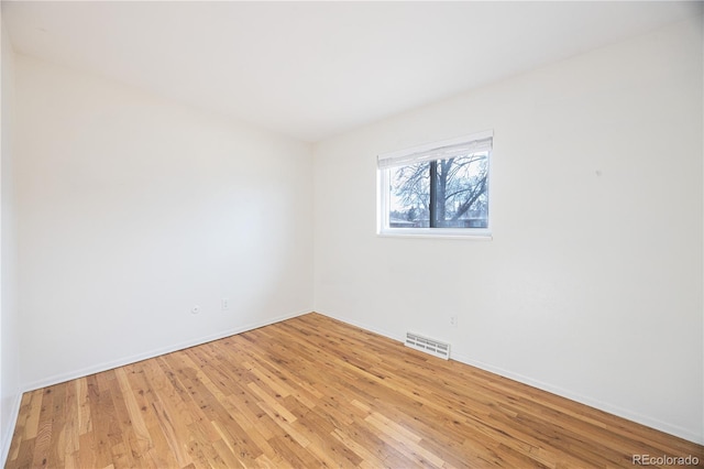 empty room with light hardwood / wood-style floors