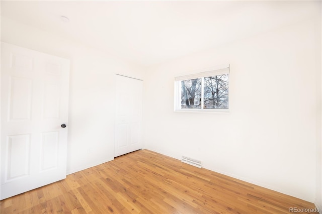 empty room with hardwood / wood-style flooring