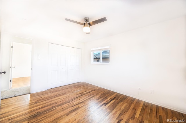 empty room with ceiling fan and wood-type flooring