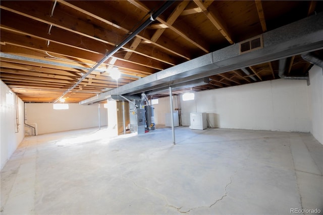 basement with washer / clothes dryer and water heater