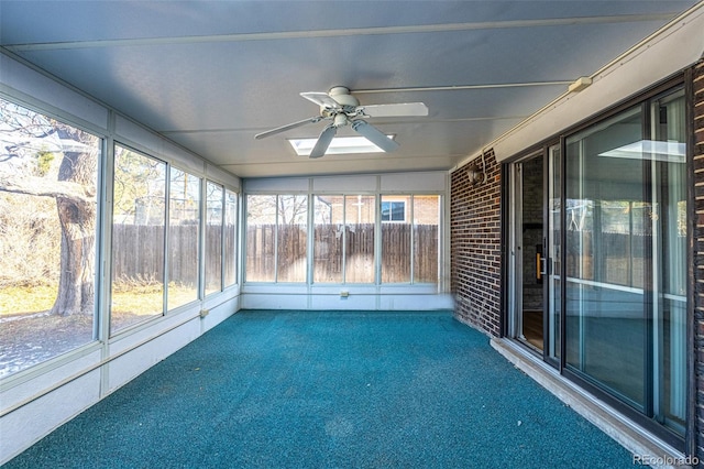 unfurnished sunroom featuring ceiling fan and a healthy amount of sunlight