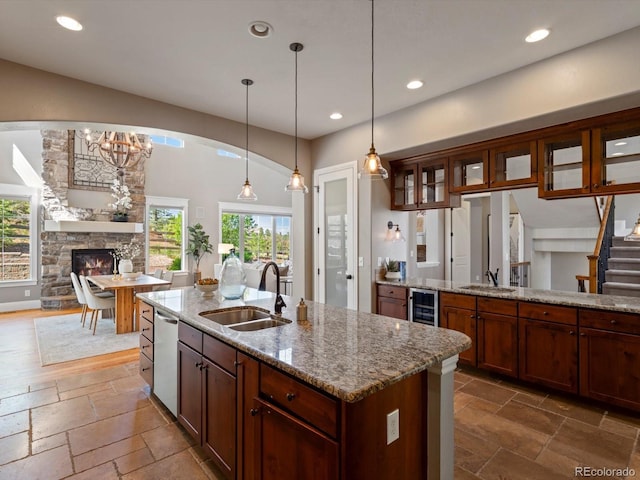 6995 S Ensenada St, Aurora, CO 80016 - kitchen featuring a sink, wine cooler, stainless steel dishwasher, stone tile floors, and recessed lighting