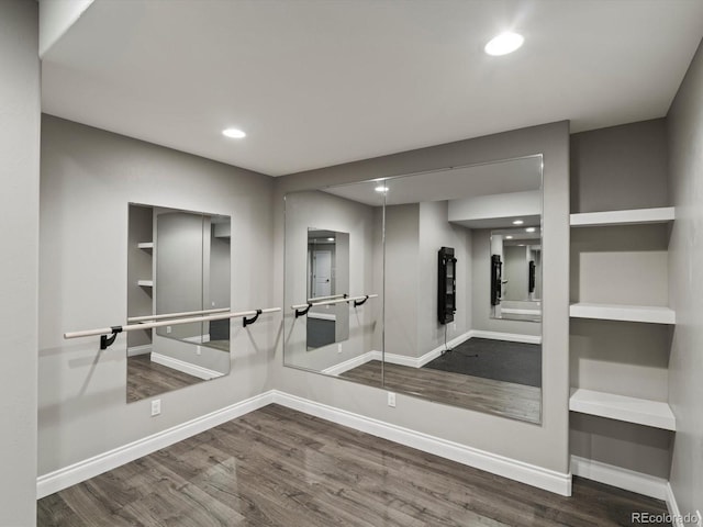 6995 S Ensenada St, Aurora, CO 80016 - empty room featuring wood finished floors, baseboards, recessed lighting, and elevator
