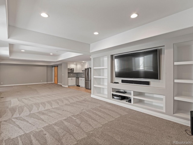 6995 S Ensenada St, Aurora, CO 80016 - unfurnished living room with light carpet, baseboards, recessed lighting, and built in shelves