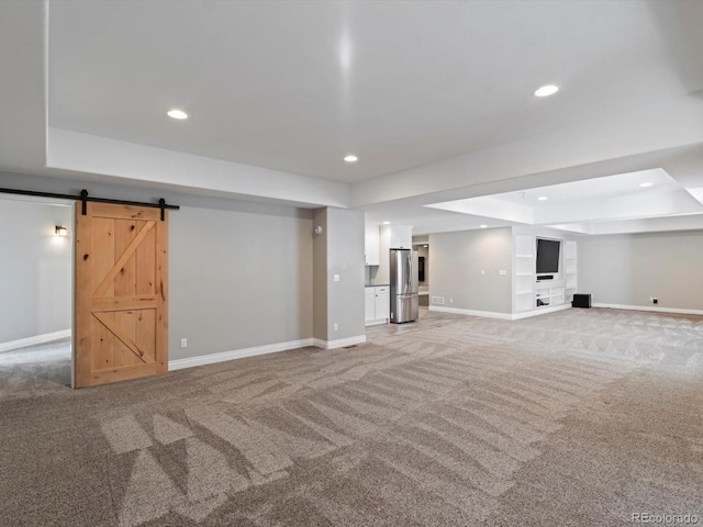 6995 S Ensenada St, Aurora, CO 80016 - finished basement featuring freestanding refrigerator, light carpet, baseboards, recessed lighting, and a barn door