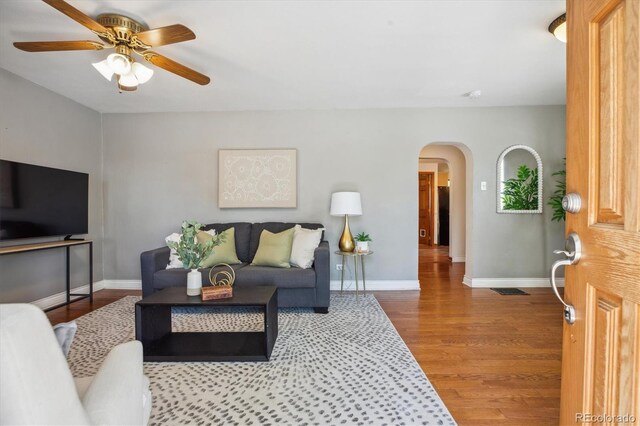 2311 W 46th Ave, Denver, CO 80211 - living room featuring arched walkways, a ceiling fan, wood finished floors, and baseboards