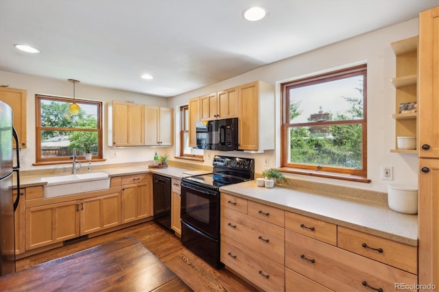 2311 W 46th Ave, Denver, CO 80211 - kitchen with black appliances, a sink, light brown cabinets, healthy amount of natural light, and recessed lighting
