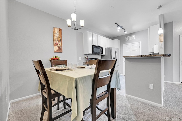 17442 Nature Walk Trl Unit 105, Parker, CO 80134 - dining space featuring light colored carpet, a chandelier, and track lighting