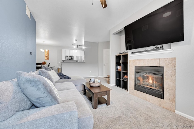 17442 Nature Walk Trl Unit 105, Parker, CO 80134 - carpeted living area with a tile fireplace, ceiling fan, and built in shelves