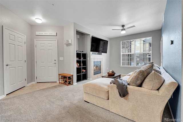 17442 Nature Walk Trl Unit 105, Parker, CO 80134 - living area with a tile fireplace, carpet, ceiling fan, and a textured ceiling