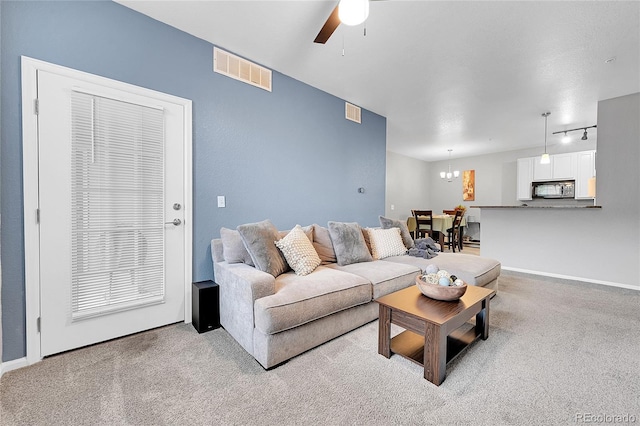 17442 Nature Walk Trl Unit 105, Parker, CO 80134 - living room with rail lighting, ceiling fan, carpet floors, and a chandelier