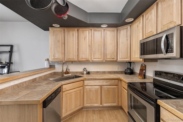 kitchen with sink, stainless steel appliances, and light brown cabinets