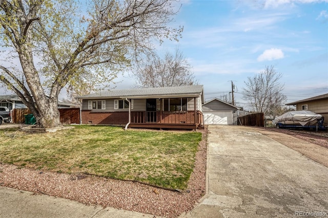 ranch-style house featuring covered porch, an outdoor structure, a front yard, brick siding, and a garage