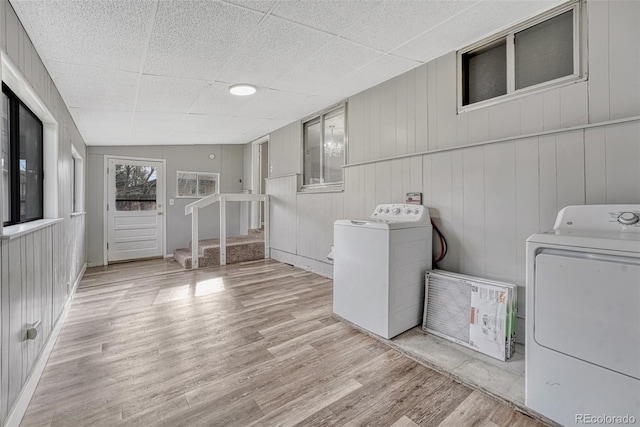 laundry area with wood finished floors and washing machine and clothes dryer